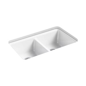 A white double-basin kitchen sink with a simple, rectangular design. Each basin is equipped with a drain at the bottom. The sink has a smooth surface and is shown from an angled perspective.