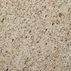 Close-up of a speckled beige granite surface with various shades of brown and gray. The texture appears rough, with a natural stone pattern composed of tiny, irregular spots and grains.