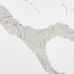 A close-up of a white surface with irregular, light gray veining patterns. The veins are scattered and resemble natural stone marbling, creating a subtle contrast against the white background.