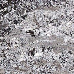 A close-up of granite featuring a mix of gray, white, and black mineral patterns. The texture is speckled, creating a natural, intricate design typical of polished stone surfaces used in countertops.