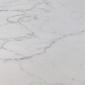 Image of a white marble surface with subtle gray veining. The stone features a smooth texture, with the veins creating organic, fluid patterns across the surface.