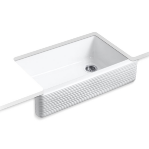 A modern white rectangular kitchen sink with a ribbed texture and integrated draining board. The sink has a sleek, minimalist design with a visible drain at the bottom.