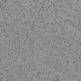 A close-up of a speckled gray textured surface. The image shows a mix of small black and white flecks evenly distributed throughout, giving it a granite-like appearance.