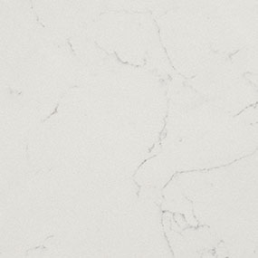 A close-up of a white marble surface with subtle gray veins running through it, creating an elegant and smooth appearance.