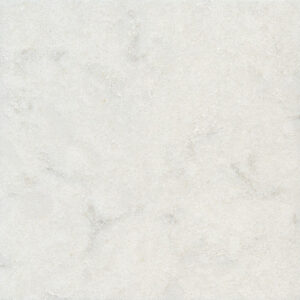 A close-up of a light grey marble surface with subtle darker veins and specks, creating a natural and elegant textured pattern. The image shows a smooth and uniform appearance typical of polished marble.