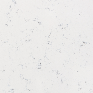 White marble surface with subtle gray veining and speckles, creating a natural and elegant appearance. The texture is smooth and polished, typical for use in countertops and flooring.