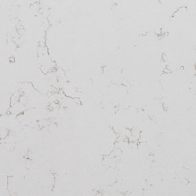 Close-up of a white marble surface with subtle gray veining throughout. The veining forms intricate, delicate patterns on the smooth surface.