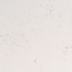 A close-up view of a white marble surface with subtle grey veining.