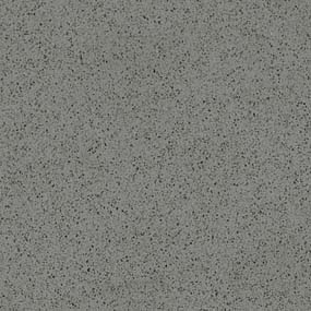 A close-up of a textured grey surface with small black speckles scattered throughout, resembling a granite or stone pattern.