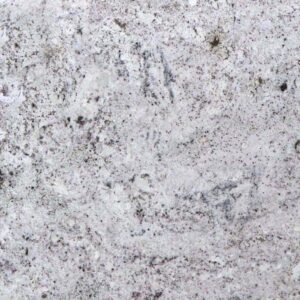 Close-up of a light gray granite surface with subtle dark speckles and swirling patterns. The texture appears rough with hints of white and darker gray areas scattered throughout.