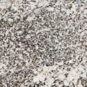 Close-up of a granite surface featuring a mix of white, gray, and black speckles. The texture is coarse, with a natural, uneven pattern typical of granite stone.