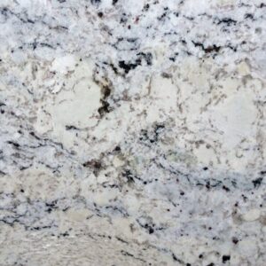 Close-up of a granite surface featuring a mix of white, gray, and black speckles. The pattern is irregular, with swirls and clusters, creating a natural, textured appearance typical of stone countertops.