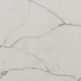 A close-up of a light-colored marble surface with subtle grey and brown veins running throughout, creating an elegant and natural pattern.