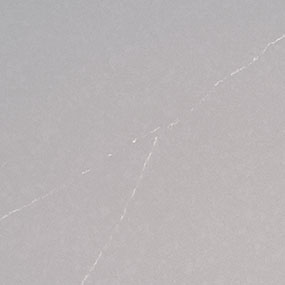 A light gray surface with subtle white, thin lines crossing diagonally, resembling faint cracks or scratches.