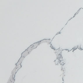 A close-up view of a white surface featuring delicate, thin, gray veins running diagonally across. The pattern resembles natural stone or marble, giving a subtle and elegant appearance.