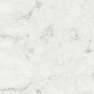 A close-up of a marble surface with a predominantly white background. The texture features subtle gray and beige veining, creating a natural, soft pattern across the stone. The surface appears smooth and polished.