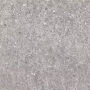 Close-up of a gray terrazzo surface with a textured pattern. The surface features small, irregularly shaped chips in various shades of gray and white embedded in the concrete.