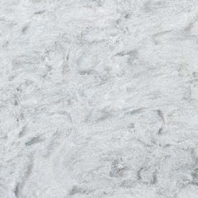 Close-up of white marble with subtle grey veining and a smooth texture.