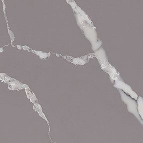 Close-up image of a smooth, gray marble surface with white veining. The veins are irregular and wavy, adding an elegant, natural pattern to the stone.