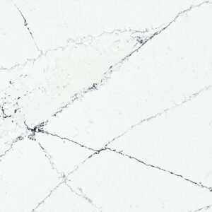 White marble surface with dark, thin veining forming an intricate web-like pattern across the stone. The bright background contrasts with the subtle gray and black lines, creating a natural and elegant appearance typical of marble texture.