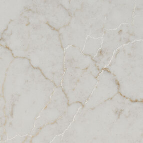 A close-up of light-colored marble with subtle gray and tan veining creating an intricate, natural pattern across the smooth surface.